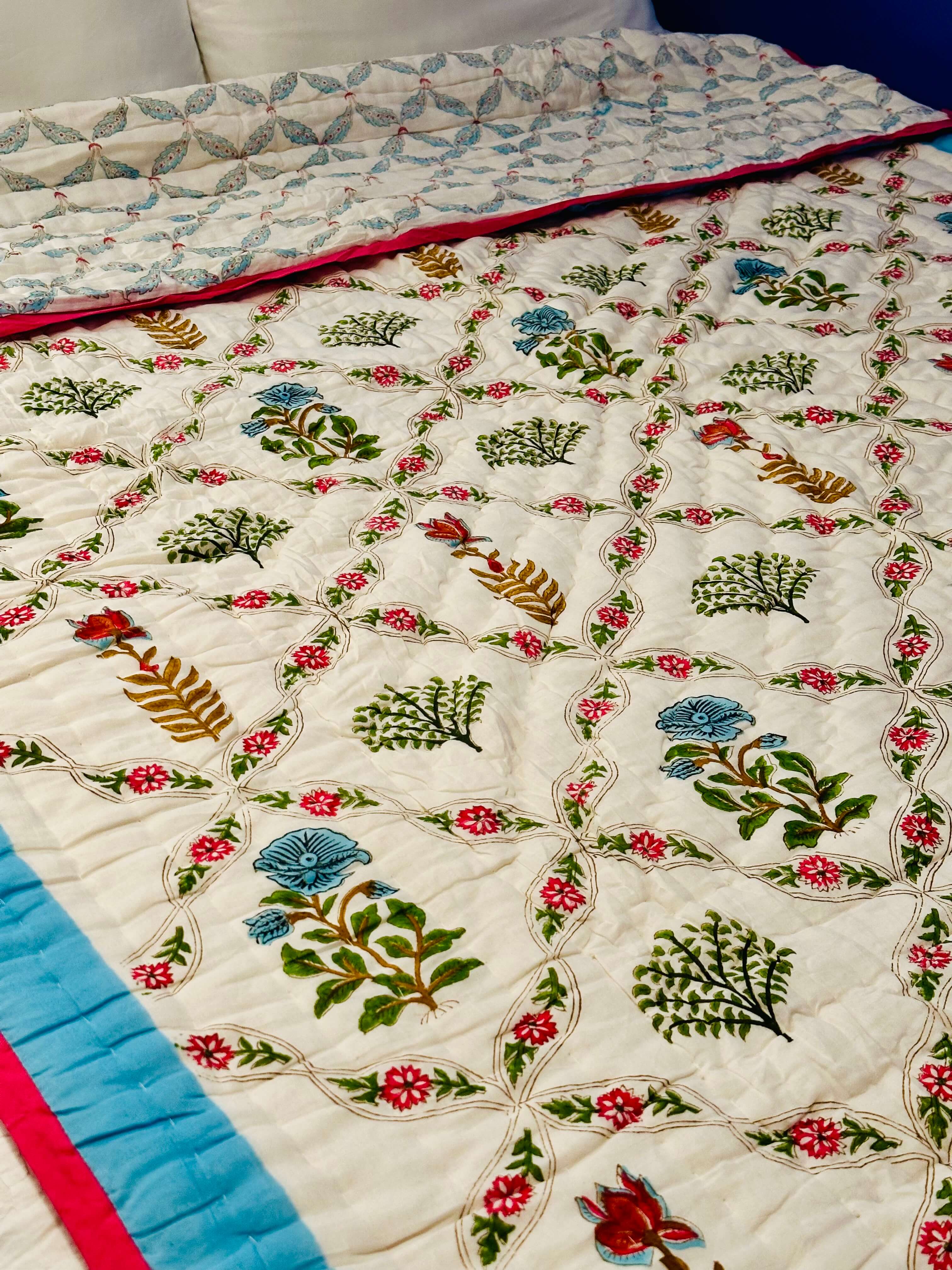 Side view of Blush Vine Reverie quilt with elegant floral pattern