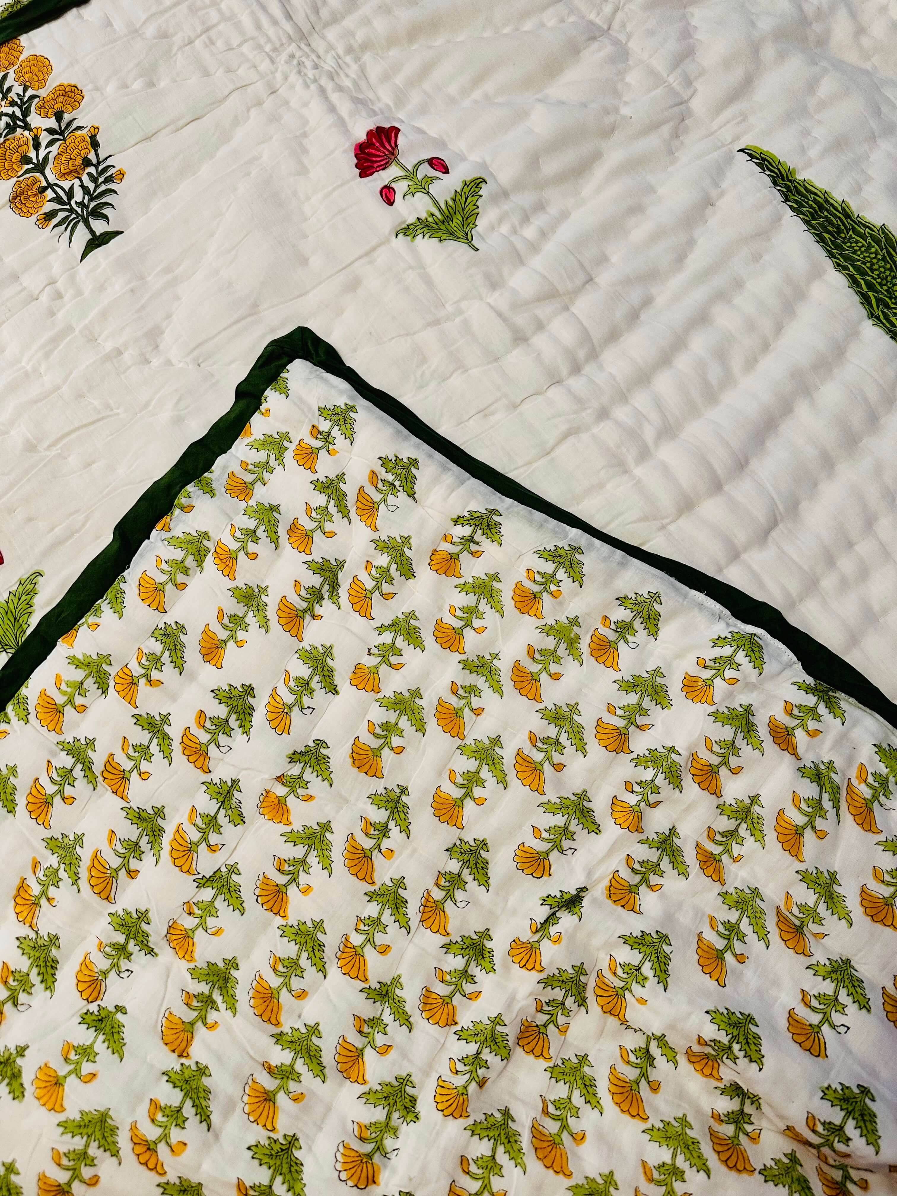 Side view of Marigold Grove quilt draped over bedding