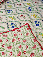Reverse side of Petals Pine quilt with delicate floral pattern