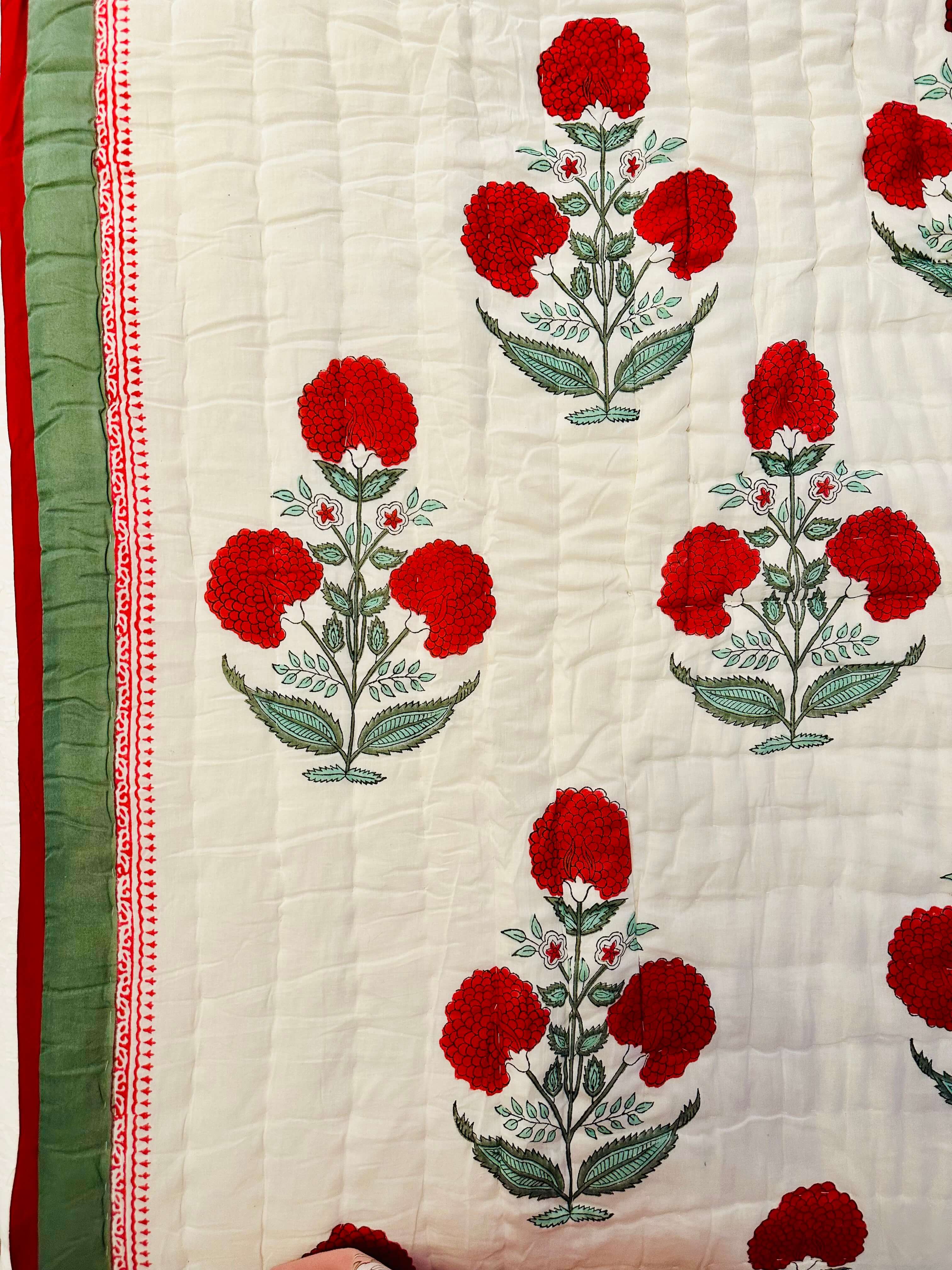Side view of Red Dahlia quilt displaying quilted texture