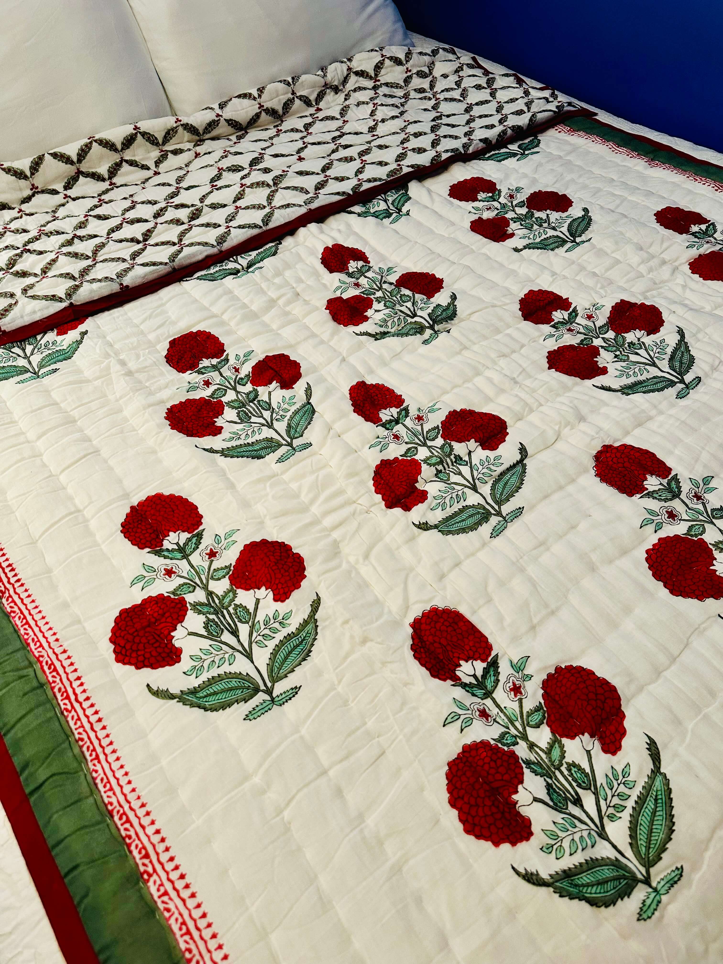Side view of Red Dahlia quilt displaying quilted texture