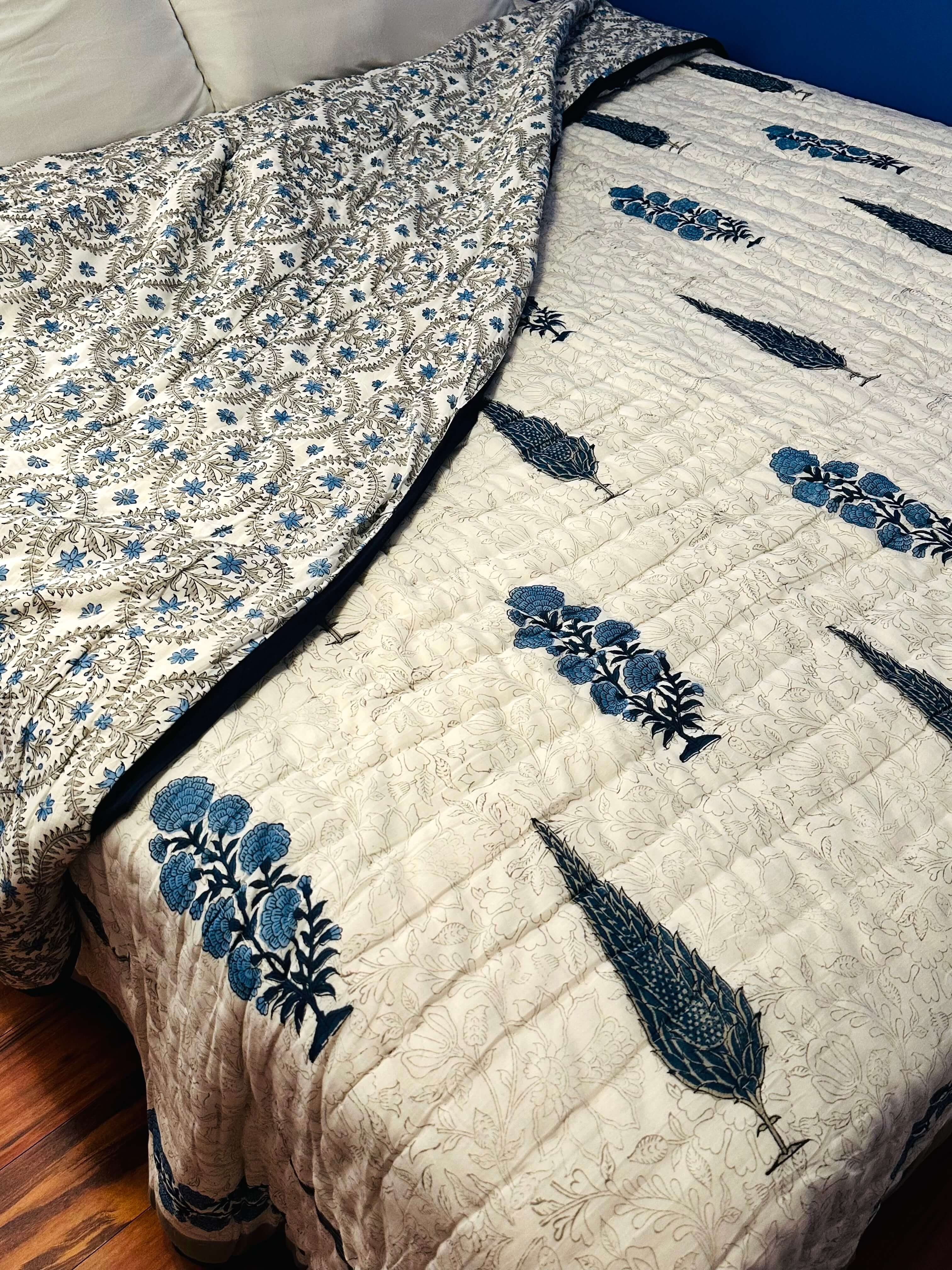 Side view of Shadow Bloom quilt with soft folds and texture